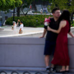 Chinese university students walking together on campus during spring break, Indianow.io